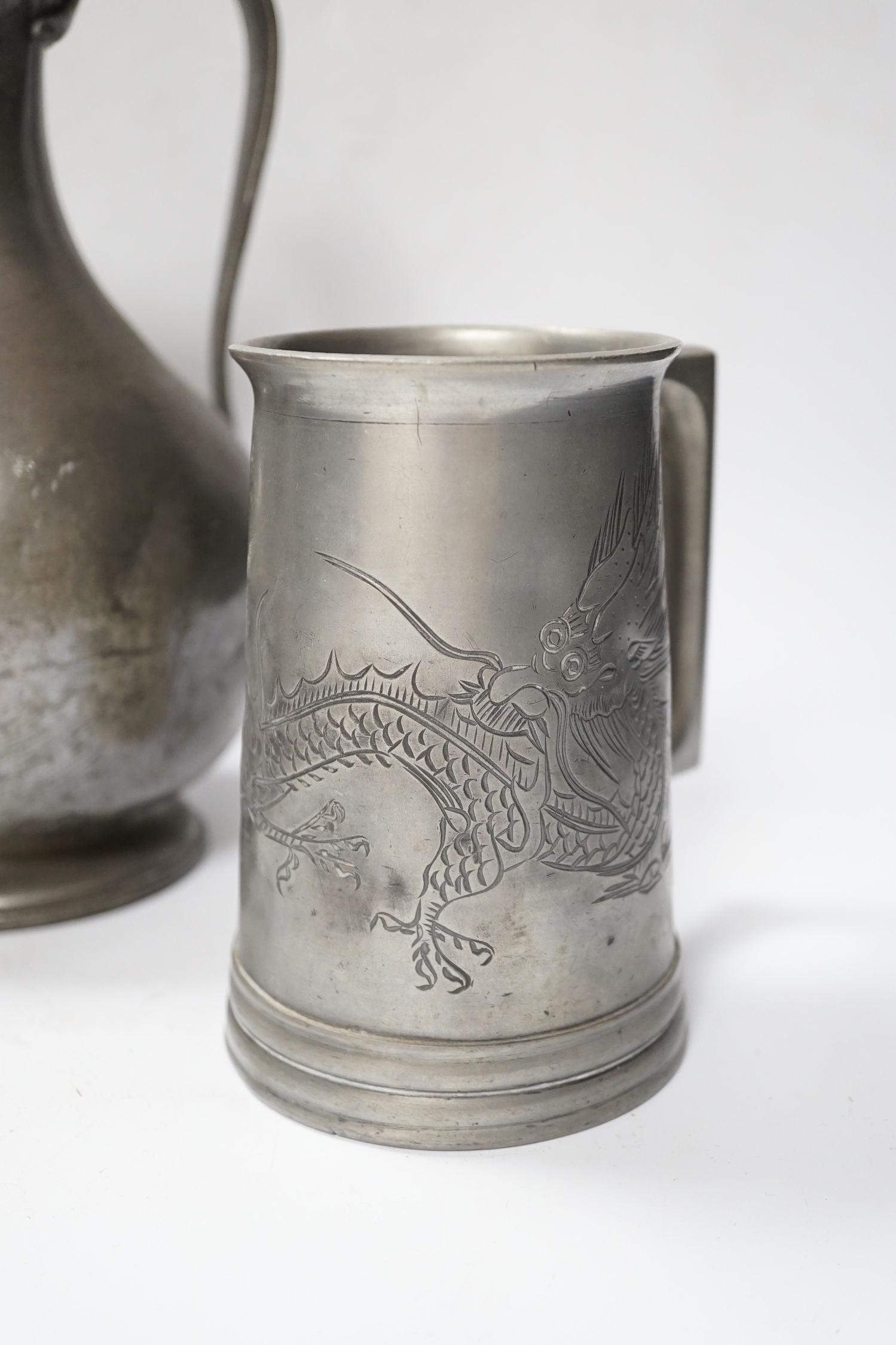 Six pewter items including an 18th-century Continental wriggle work tankard, two more tankards and two lidded jugs and a lead mounted figure of a Medieval king, lead figure 35cm high